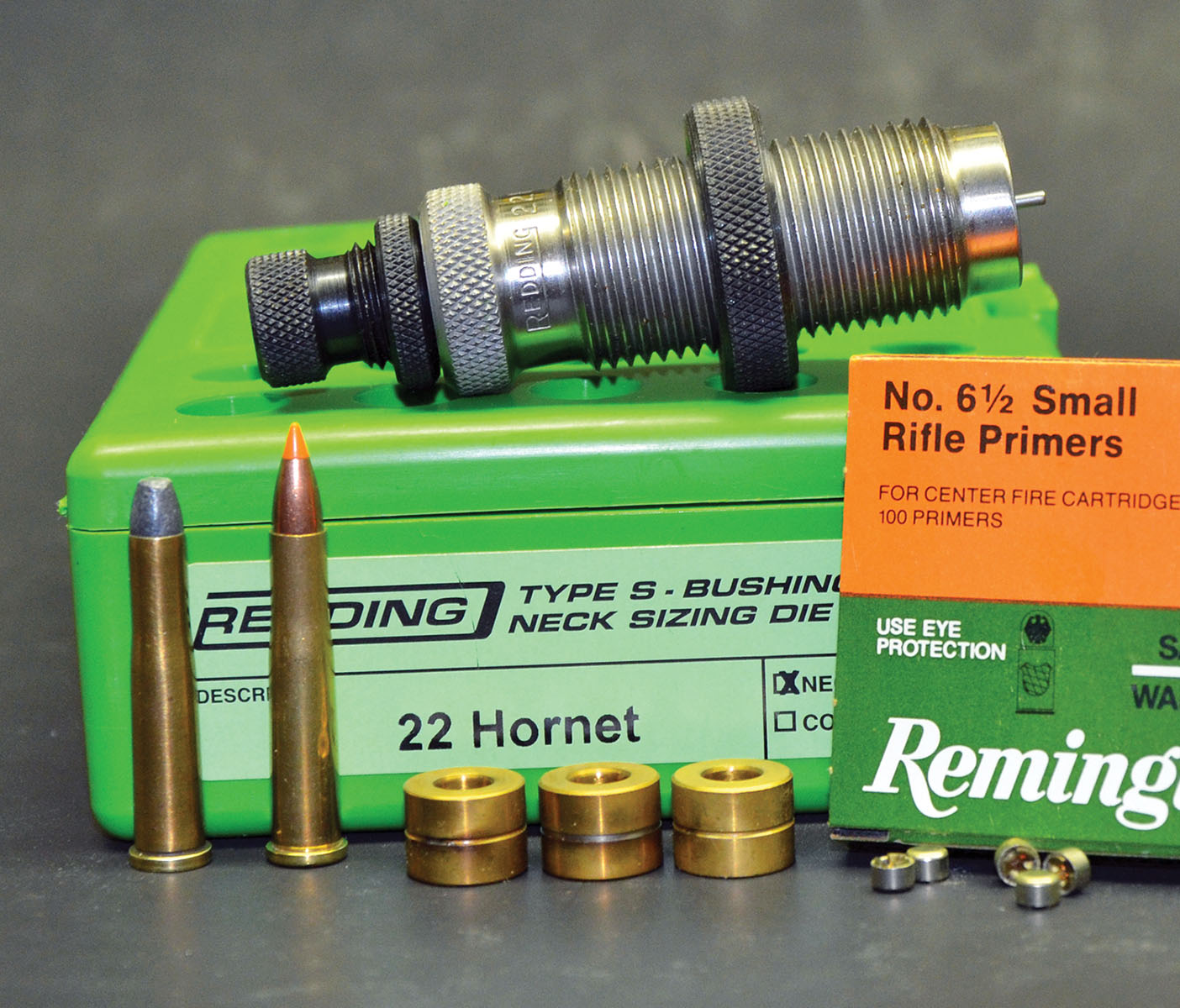 As explained in the text, accuracy often improves when cases are neck-sized considerably smaller than the neck diameter of a loaded round. Doing so is easily accomplished with a Redding Type M neck-sizing die with bushings having interior diameters varying in .001-inch increments. The 22 Hornet at left originated during the 1920s by varmint shooters who loaded the old 22 WCF case (far left) with smokeless powder.